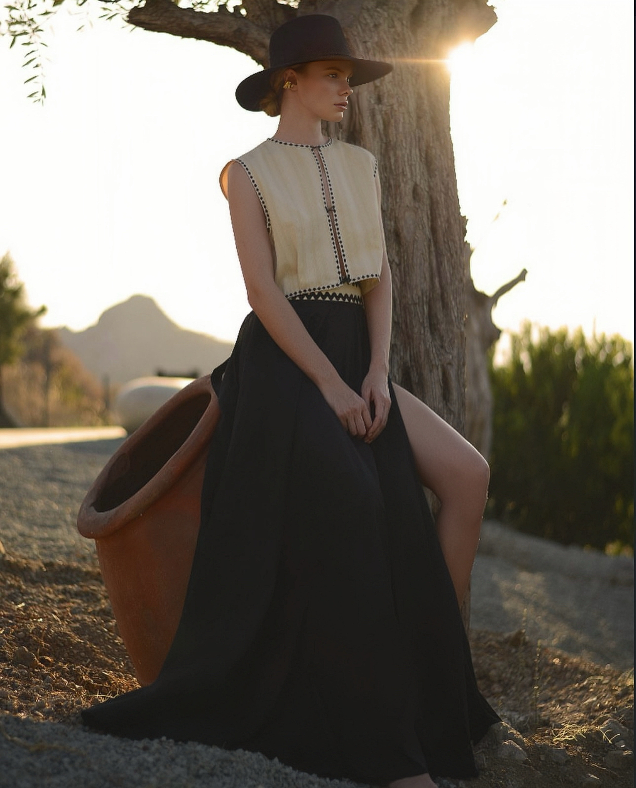 Model in a hat and black skirt at golden hour